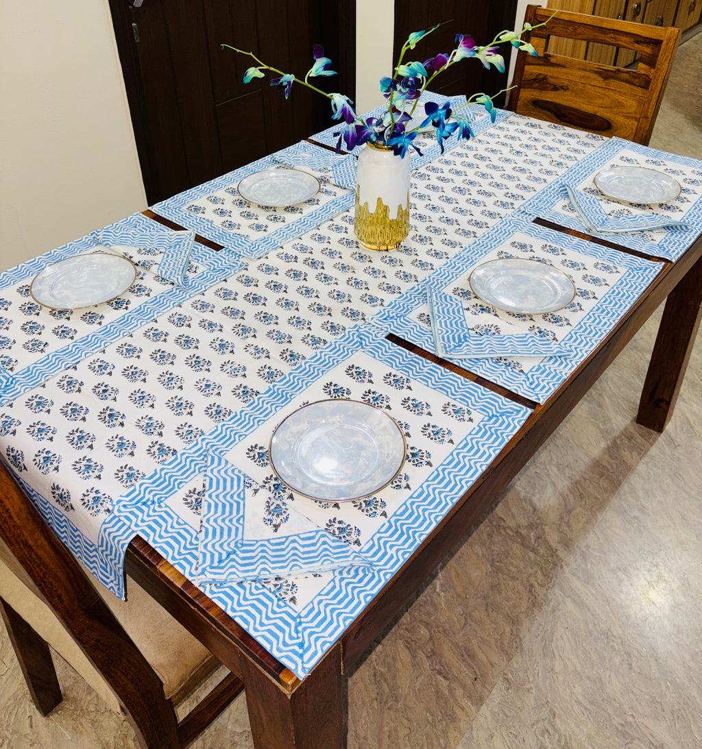 Dining table set with blue and white patterned table runner