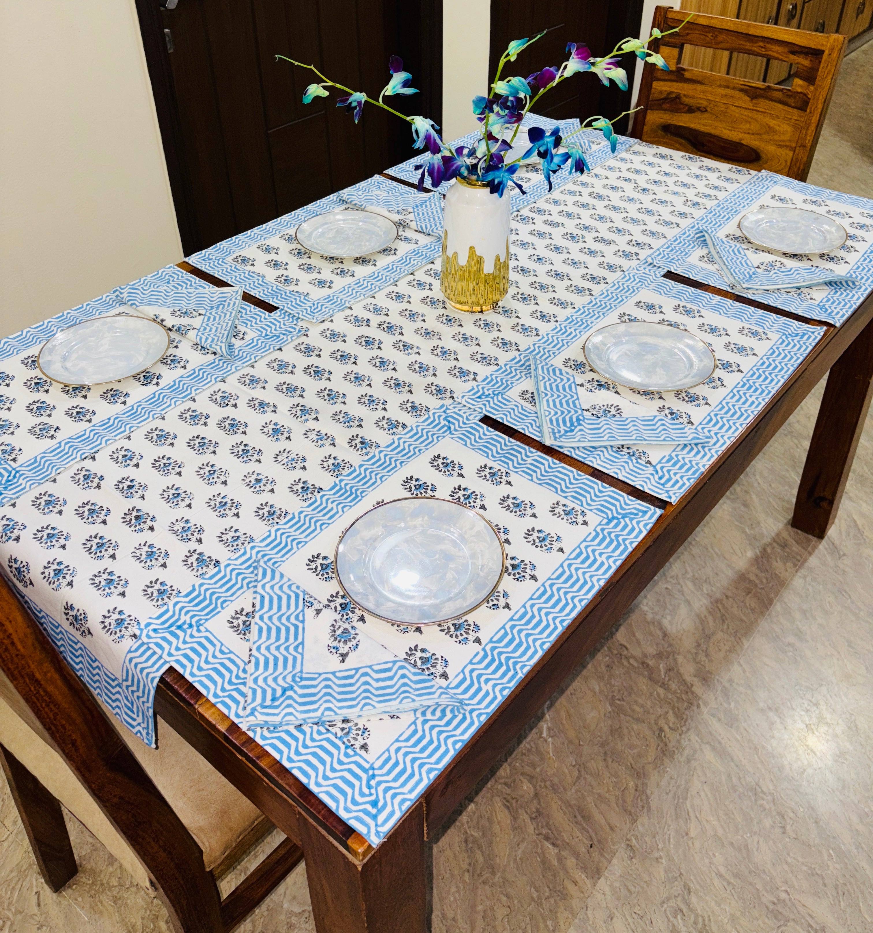 Dining table set with blue and white patterned table runner